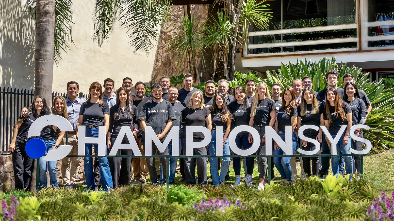The Championsys team in front of the company sign